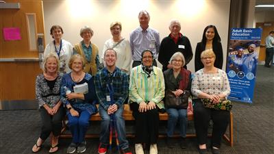 Volunteers sitting posed for a photo at Journeys reading event. Volunteers sitting posed for a photo at Journeys reading event.